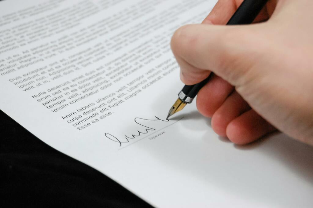 A person signing a document with a fountain pen